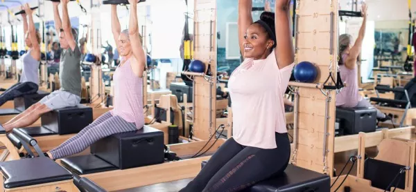 Women on pilates reformers